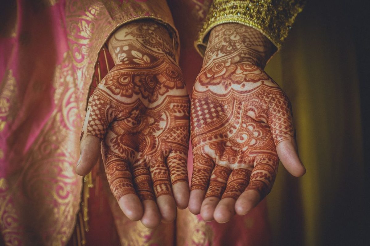 Hands adorned with intricate mehndi — beautification training